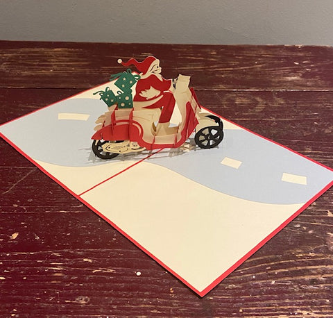Santa Riding a Scooter (Green Presents)